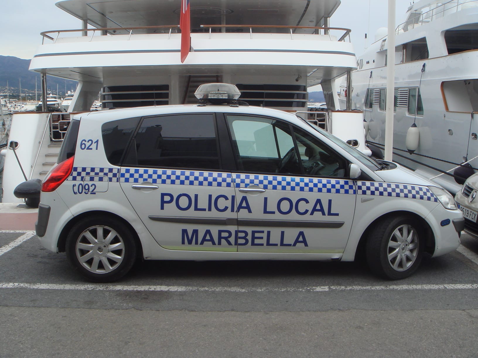 A marked Policía Local Marbella car parked on the quayside